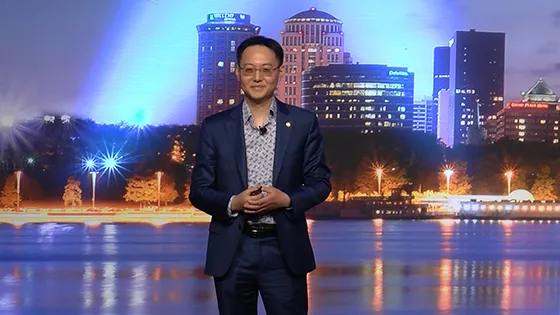 Gary speaking in front of a large board